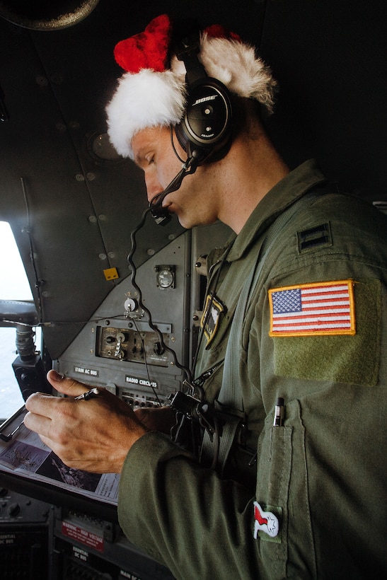 Air Force Capt. Darryl Lawlor checks a flight map during Operation Christmas Drop over the Micronesian islands, Dec. 5, 2016. Lawlor is a navigator assigned to the 36th Airlift Squadron. Air Force photo by Senior Airman Delano Scott