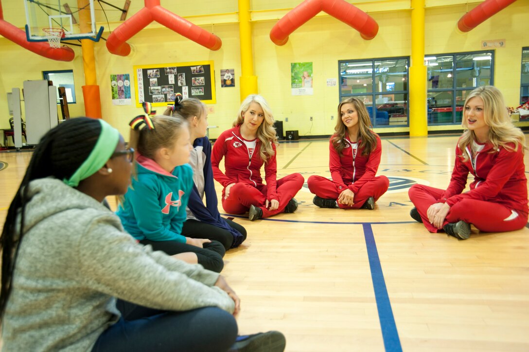 Alison, Kelsey and Claire (right to left), Kansas City Chiefs cheerleaders, meet with children of military families during a cheerleading clinic Dec. 3, 2016 at Joint Base Andrews, Md. During the clinic, the NFL cheerleaders demonstrated dance techniques used during the Chiefs' home games. (U.S. Air Force photo by Staff Sgt. Joe Yanik)
