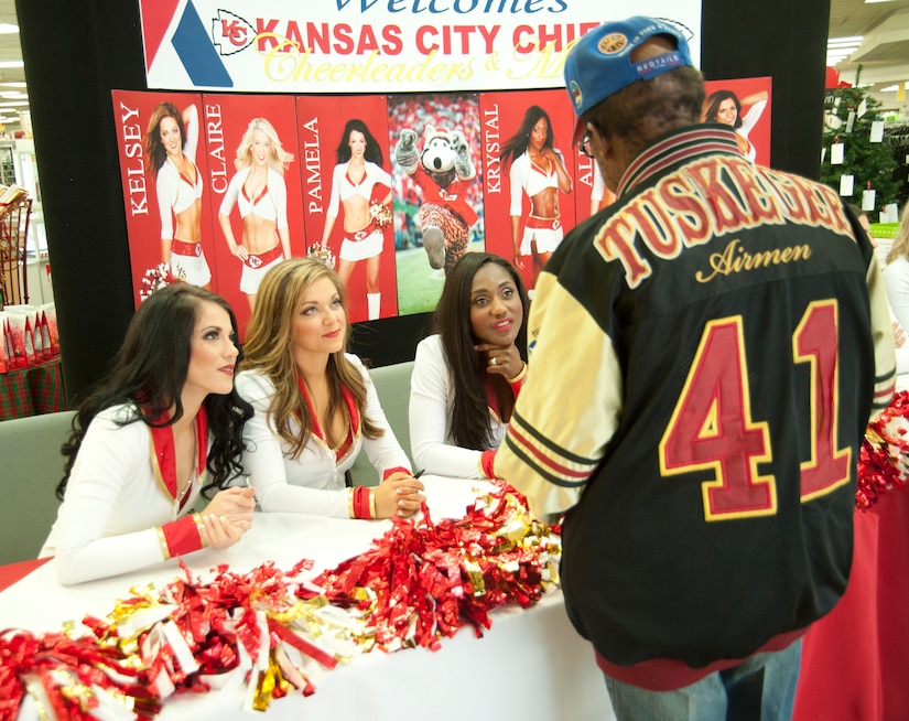 Norman Artis (right), a U.S. Air Force veteran, speaks with Kansas City Chiefs cheerleaders Dec. 3, 2016 at Joint Base Andrews, Md. The NFL cheerleaders met with and signed autographs for Artis and other Main Exchange patrons as part of a military appreciation event held on base. (U.S. Air Force photo by Staff Sgt. Joe Yanik)