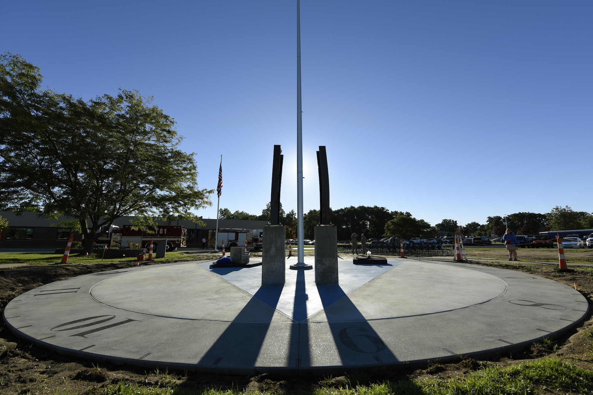 The shadow of the flagpole falls across the clock face of the Northwest Ohio 9/11 Memorial located at the center of the 180th Fighter Wing in Swanton, Ohio, on the morning of the 15th anniversary of the attacks on Sept. 11, 2001, marking the exact time the first plane struck the north tower of the World Trade Center. The monument memorializes the loss of nearly 3,000 lives during the attacks and since. (U.S. Air National Guard photo by Staff Sgt. Shane Hughes)