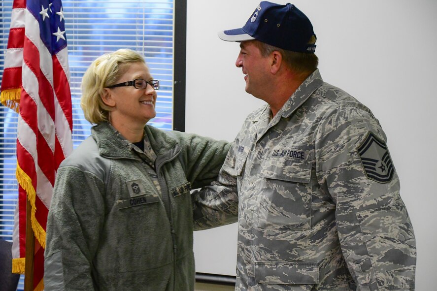 U. S. Air Force Senior Master Sgt. Frederick Maffeo, 307th Medical Squadron superintendent, shares a light moment with Chief Master Sgt. Shelley Cohen, 307th Bomb Wing command chief, during his retirement gathering at Barksdale Air Force Base, La., Dec. 4, 2016.  Maffeo retires after 25 years of service. (U.S. Air Force photo by Master Sgt. Laura Siebert/released). 