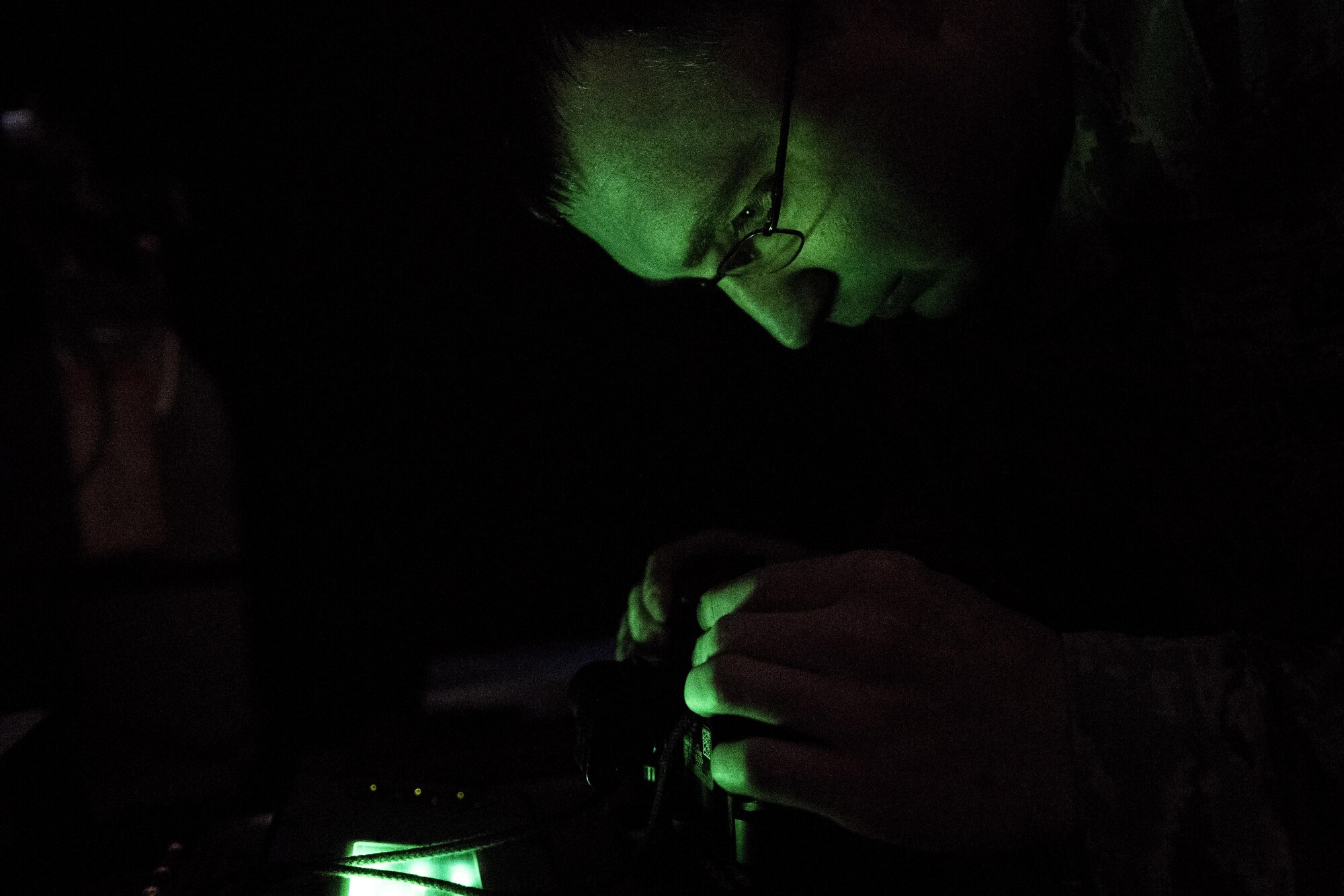 Tech. Sgt. Ryan Murray, 305th Operation Support Squadron Aircrew Flight Equipment quality assurance NCO in charge, inspects a pair of night vision goggles in the dark room at the AFE at Joint Base McGuire-Dix-Lakehurst, New Jersey, Nov. 30, 2016. Murray was recently nominated to represent the 305th Air Mobility Wing and Air Mobility Command for an Air Force-level award. 
