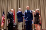 Air Force Lt Col Mike Davis has his new rank of Colonel pinned on by his parents and wife Kristi in a ceremony on Dec. 2. 