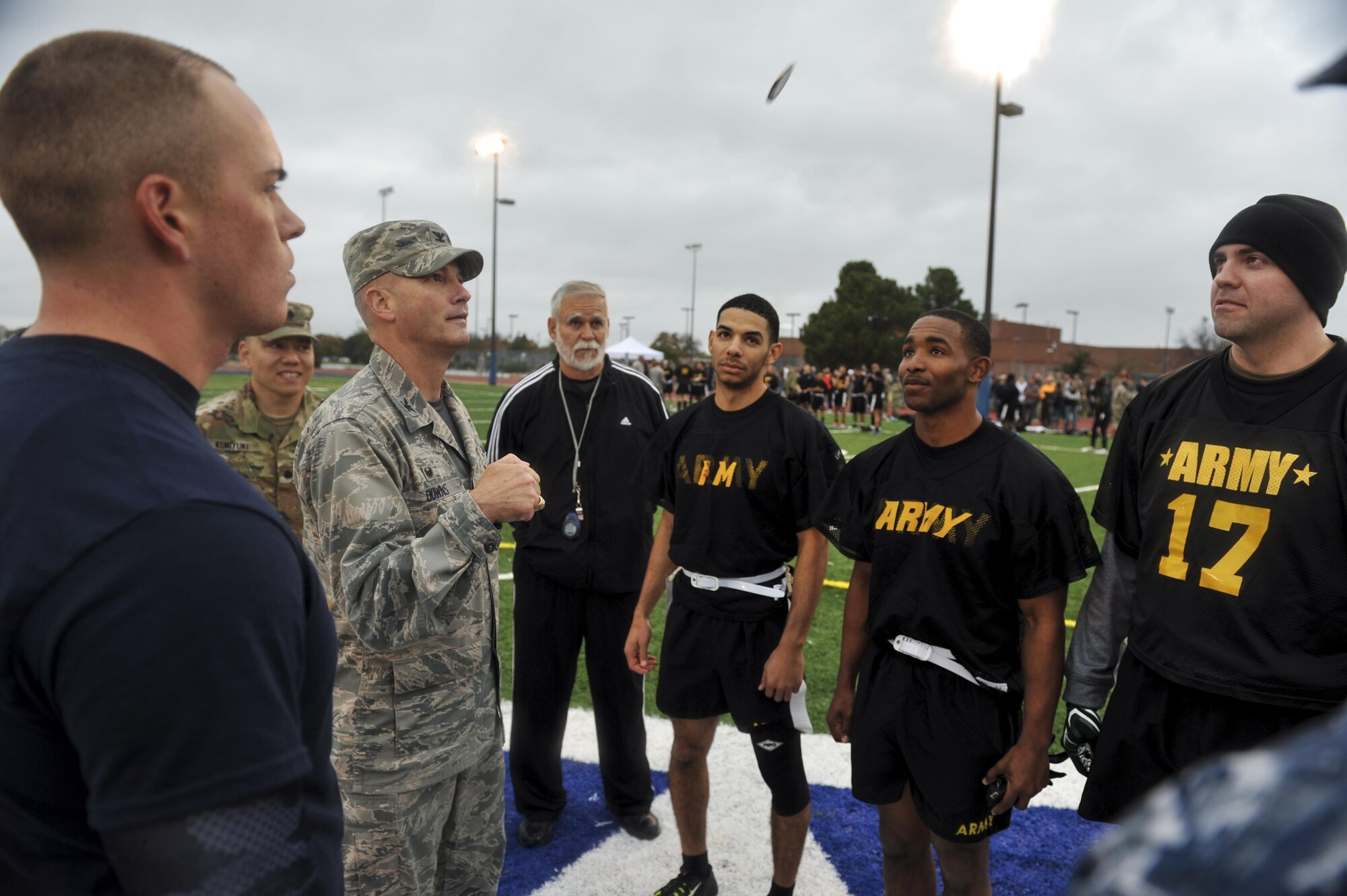 U.S. Air Force Col. Michael Downs, 17th Training Wing Commander, flips a coin at the start of the Army vs. Navy football game at the Mathis Fitness Center football field on Goodfellow Air Force Base, Texas, Dec. 2, 2016. The coin toss determines which team receives the ball first. (U.S. Air Force photo by Senior Airman Devin Boyer/Released)