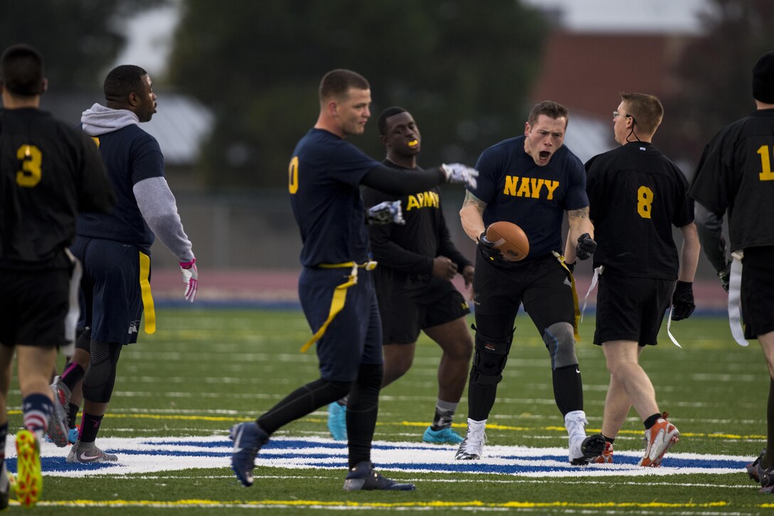 U.S. Navy Petty Officer 2nd Class Aaron Meriwether, Center for Information Warfare Training Detachment Goodfellow student, celebrates after a successful first down during the Army vs. Navy football game at the Mathis Fitness Center football field on Goodfellow Air Force Base, Texas, Dec. 2, 2016. The Army and Navy flag football game is an annual tradition at Goodfellow. (U.S. Air Force photo by Senior Airman Devin Boyer/Released)