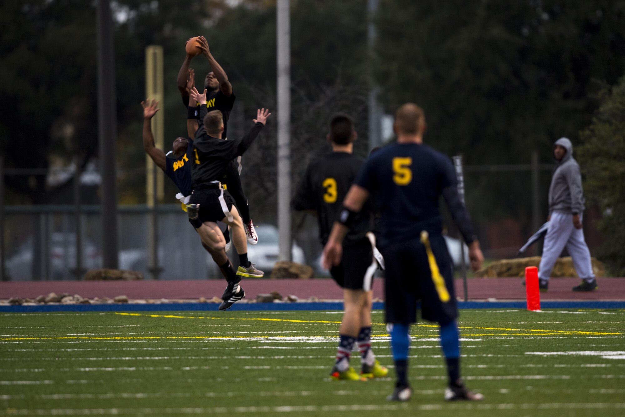 A U.S. Army wide receiver catches a football during the Army vs. Navy football game at the Mathis Fitness Center football field on Goodfellow Air Force Base, Texas, Dec. 2, 2016. The flag football game is a tradition at Goodfellow intended to boost morale among the friendly rivalry. (U.S. Air Force photo by Senior Airman Devin Boyer/Released)