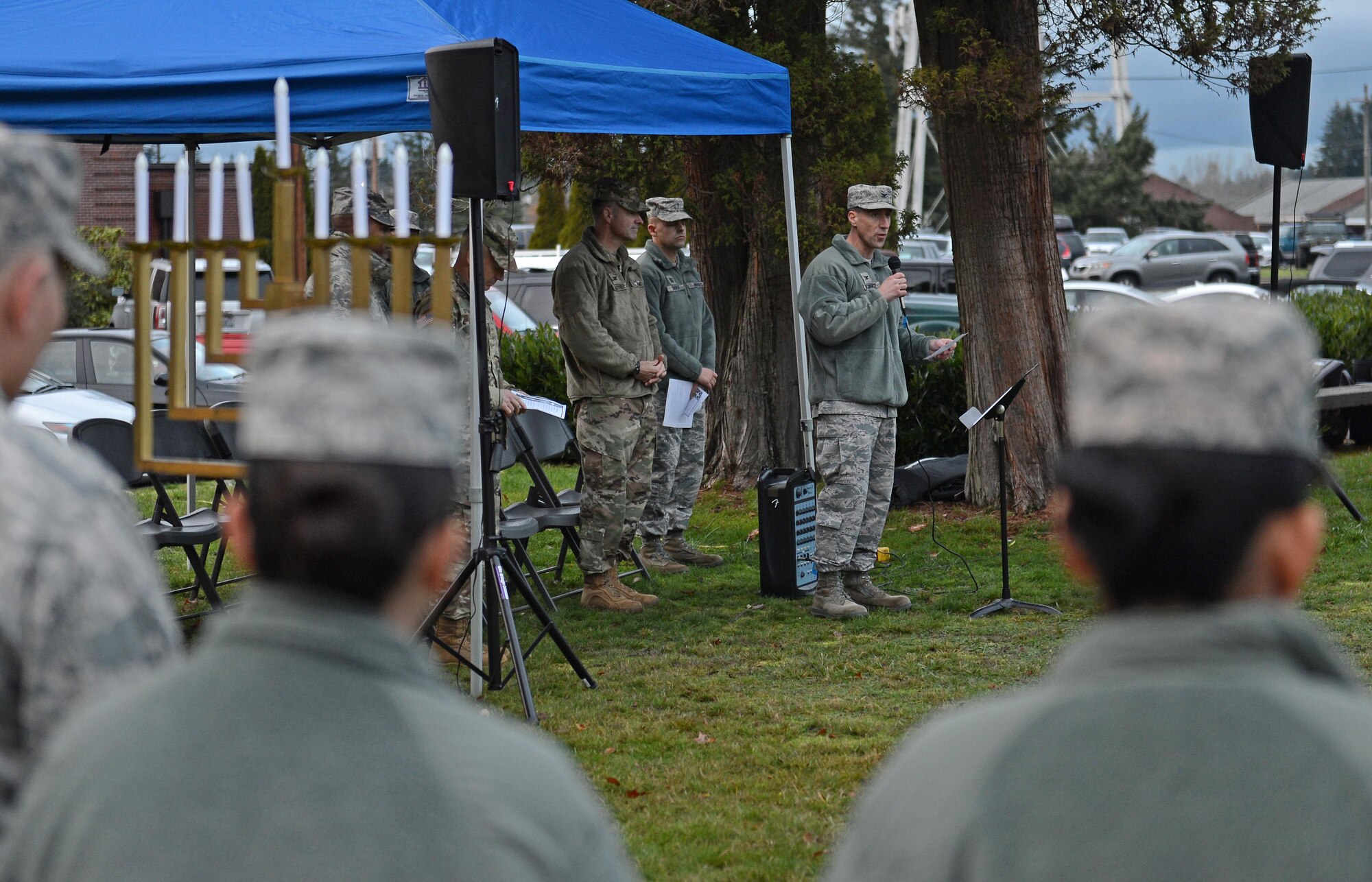Col. Leonard Kosinski, 62nd Airlift Wing commander, speaks with service members during the McChord Field Annual Tree Lighting Ceremony Dec. 5, 2016 at Joint Base Lewis-McChord, Wash. Following his speech, Kosinski, with the help of children lit the Menorah. (U.S. Air Force photo/Senior Airman Divine Cox)
