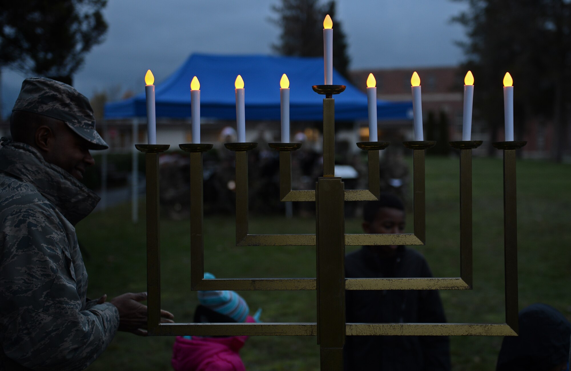 Joint Base Lewis McChord leadership and children light the Menorah during the McChord Field Annual Tree Lighting Ceremony Dec. 5, 2016 at Joint Base Lewis-McChord, Wash. Along with the Menorah, a Christmas tree was also lit during the ceremony. (U.S. Air Force photo/Senior Airman Divine Cox)