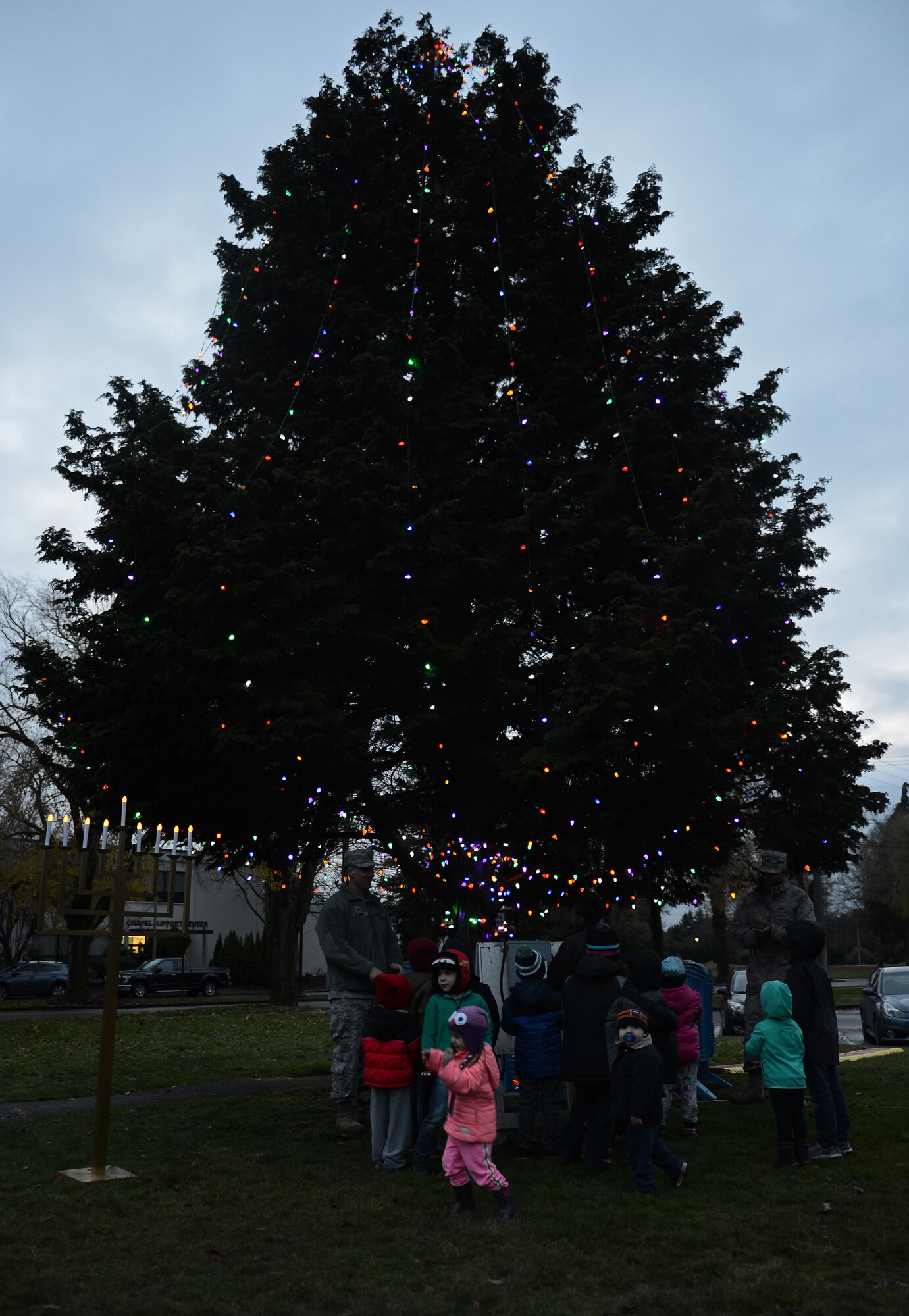 Team McChord families surround the holiday tree during the McChord Field Annual Tree Lighing Ceremony Dec. 5, 2016 at Joint Base Lewis-McChord, Wash. Santa Claus and his elves visited children, while families participated in several events following the ceremony. (U.S. Air Force photo/Senior Airman Divine Cox)