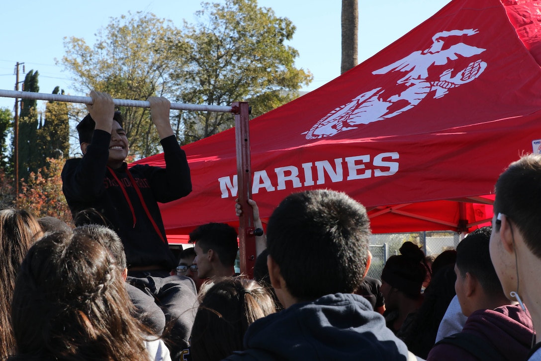 A Franklin High School student conducts pull-ups during the Marine Corps pull-up challenge while Action Sports Association High School tour put on a show for the high school, Dec. 2, 2016. The ASA High School tour is a high-energy action sports circuit that visits cities across the United States supporting the Anti-Defamation League’s No Place for Hate campaign and the campaign for Tobacco-Free Kids. (U.S. Marine Corps photo by Staff Sgt. Alicia R. Leaders/Released) 