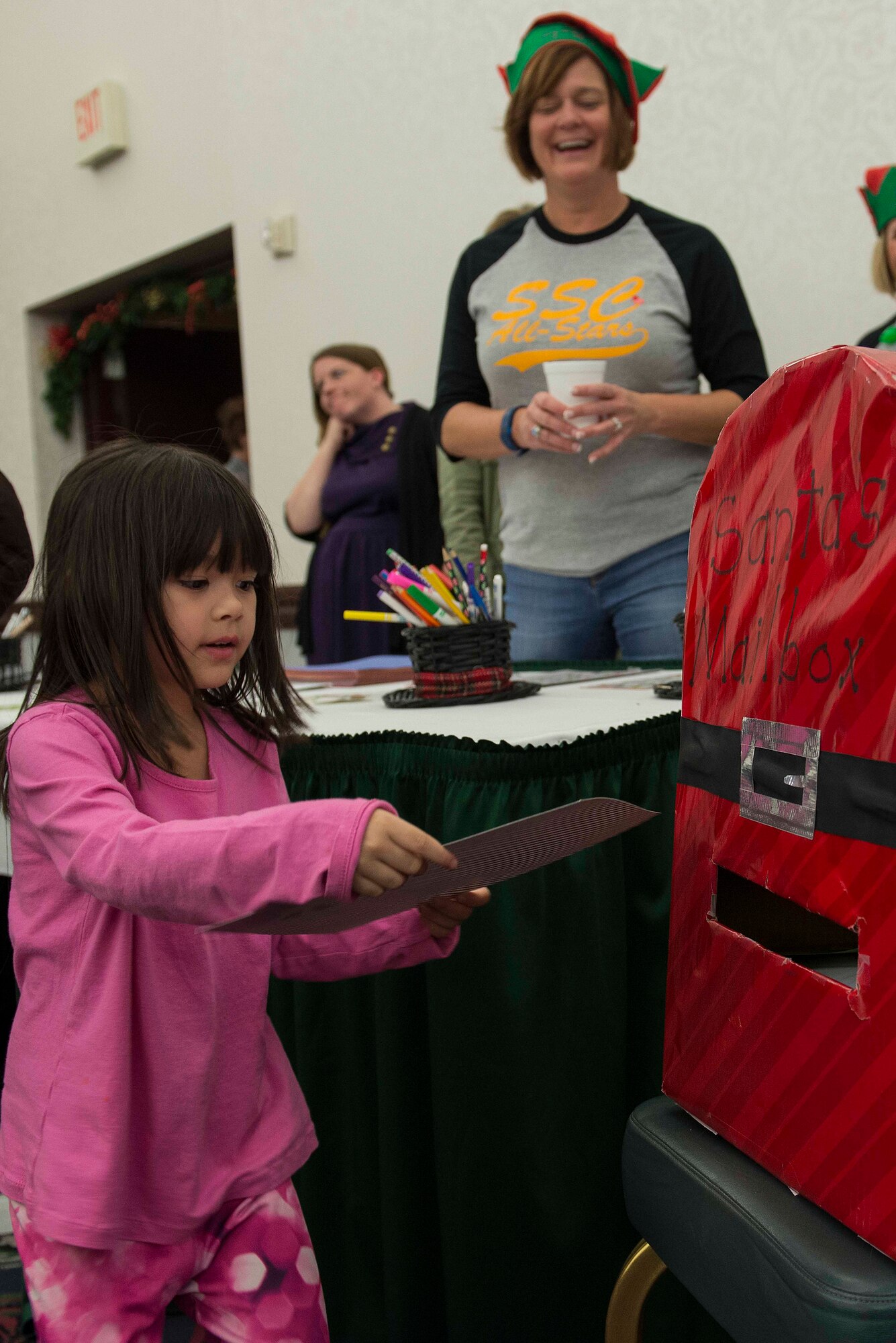 Many Scott Air Force Base service members and families attended the annual holiday party and tree lighting event Nov. 30, 2016. During the party, families were able to meet Santa and Mrs. Claus, participate in crafts, listen to the Scott AFB Youth Program's Choir sing holiday songs, and pick out a Christmas tree donated by Trees for Troops. Thank you to the coordinators and all the volunteers who made this event an enjoyable and memorable evening for so many people. (U.S. Air Force photo by Senior Airman Megan Friedl)