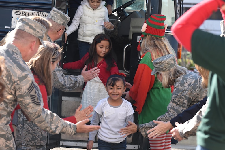 Children from local communities are greeted by Team V members during the 58th annual Operations Kids Christmas, Dec. 2, 2016, Vandenberg Air Force Base, Calif. Since its inception in the 1950s, OKC has been an opportunity for uniformed members to give back to the community and provide children a day full of games, gifts, and recreational activities. (U.S. Air Force photo by Senior Airman Robert J. Volio/Released)