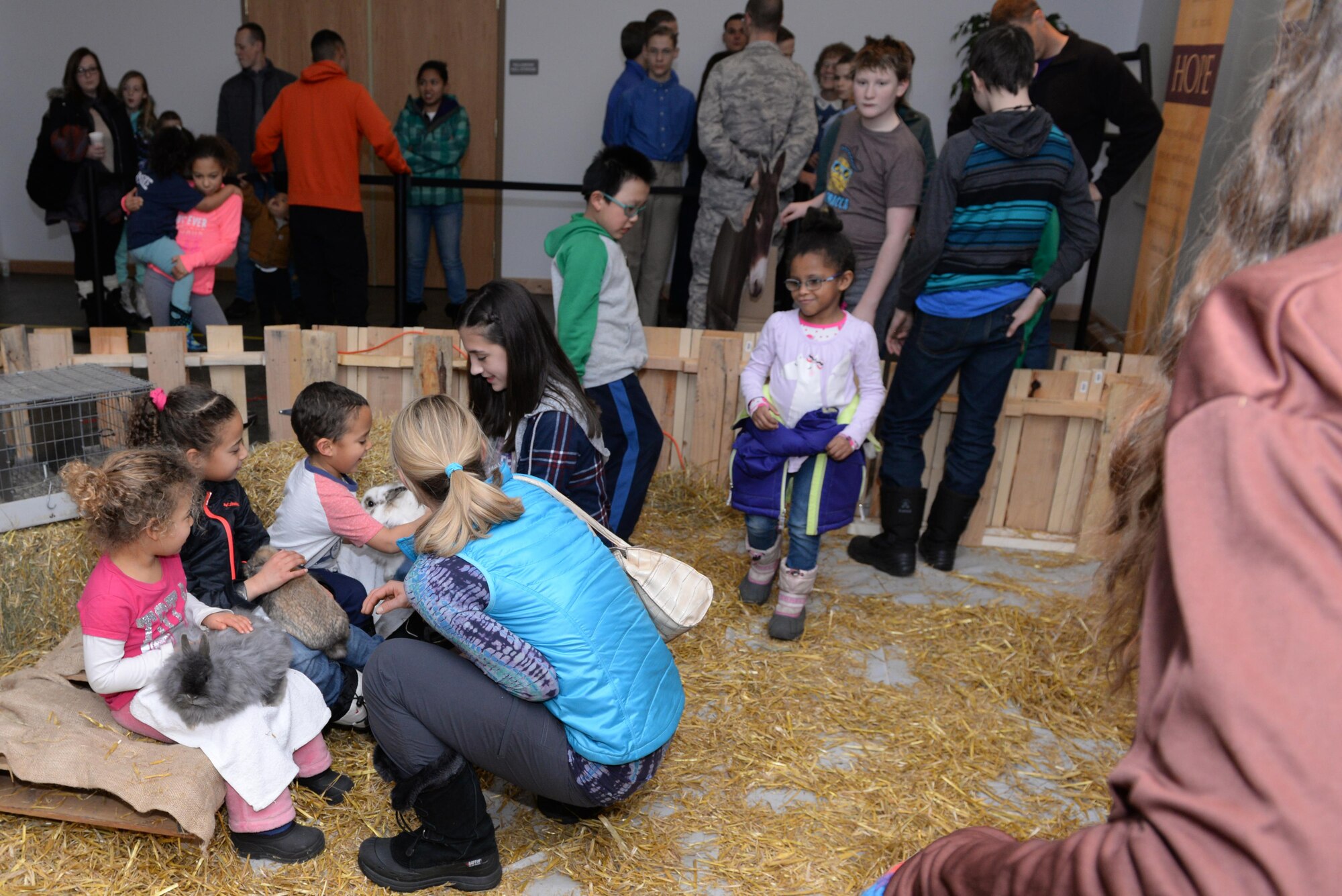 Children hold rabbits at the base Base Chapel Dec. 2, 2016, on Eielson Air Force Base, Alaska. The chapel hosted a Christmas tree lighting and a petting zoo as part of the annual Winter Festival. (U.S. Air Force photo by Airman Eric M. Fisher)