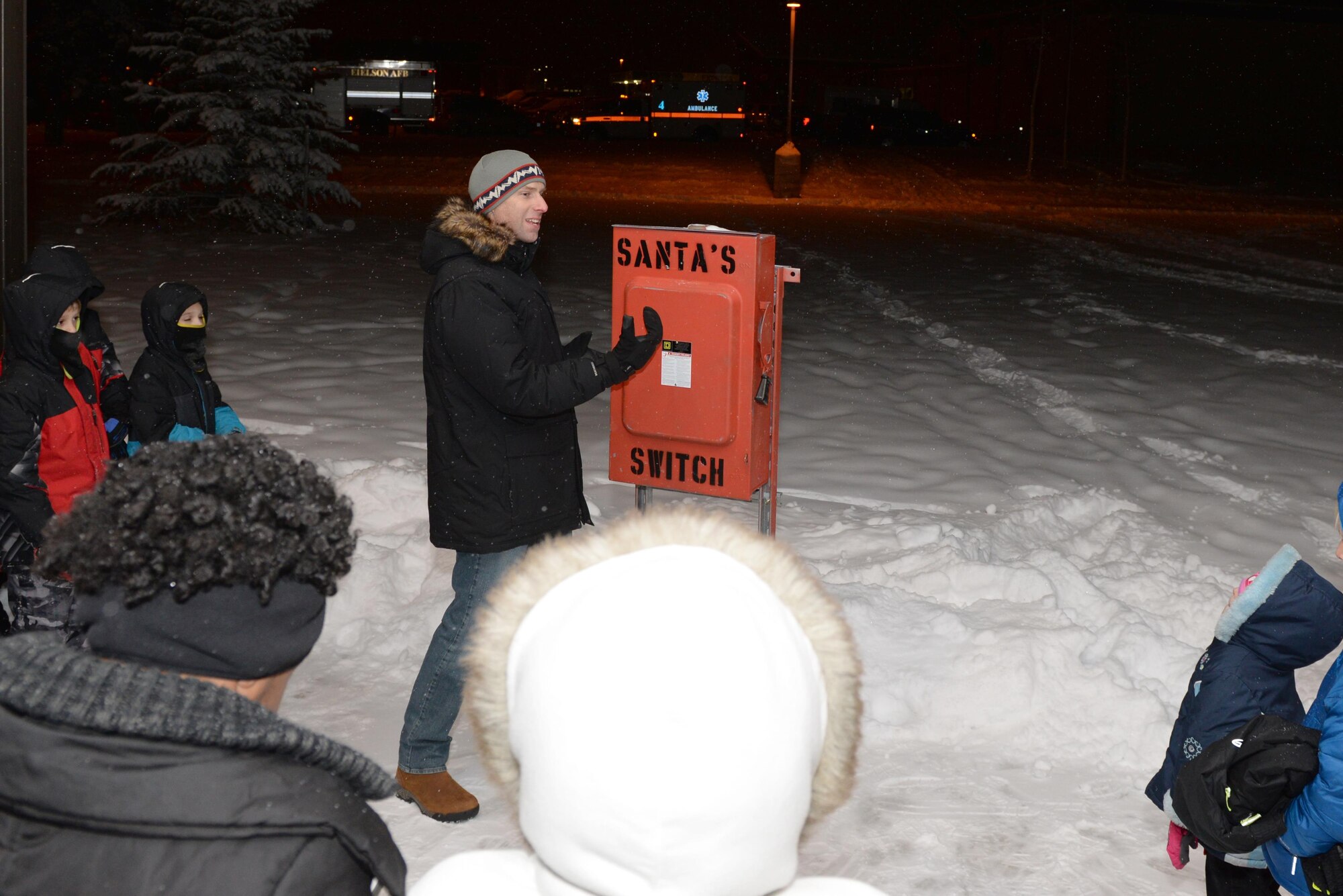 U.S. Air Force Col. David Mineau, the 354th Fighter Wing commander, speaks to the audience before lighting the Christmas tree Dec. 2, 2016, at Eielson Air Force Base, Alaska. Mineau later picked children to flip the master switch and light the tree. (U.S. Air Force photo by Airman Eric M. Fisher)