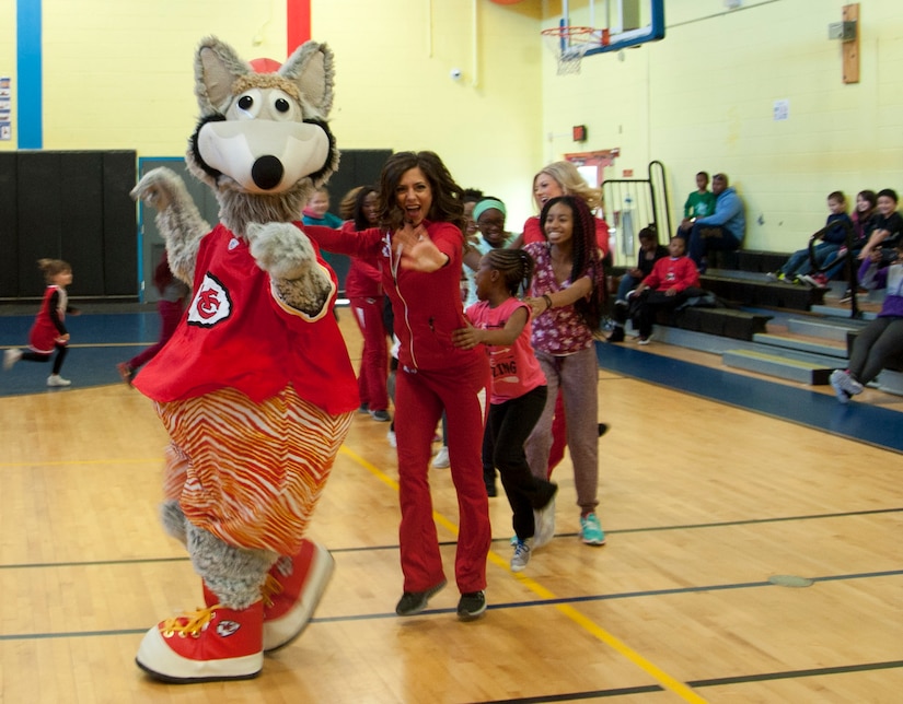 Kansas City Chiefs cheerleaders and the team mascot, K.C. Wolf, form a dance line with children of military families Dec. 3, 2016, at Joint Base Andrews, Md. The dancing was part of a cheerleading clinic held by the NFL cheerleaders at the base’s youth center during a military appreciation event. (U.S. Air Force photo by Staff Sgt. Joe Yanik)