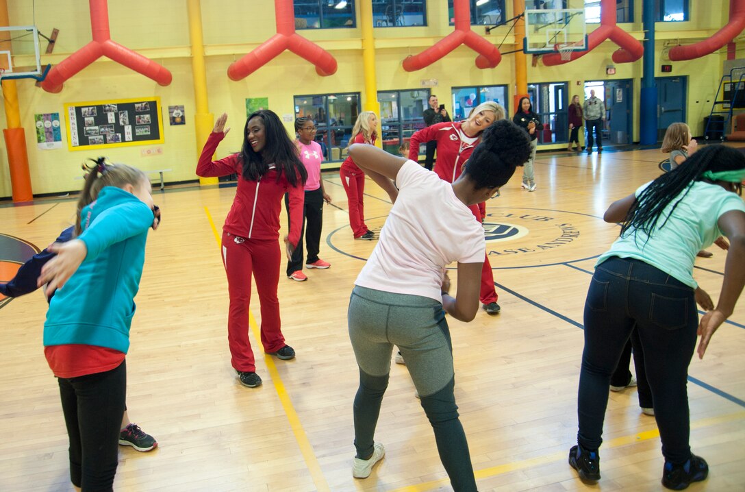 The Kansas City Chiefs cheerleaders dance with children of military families Dec. 3, 2016 at Joint Base Andrews, Md., during a cheerleading clinic. The clinic was part of a military appreciation event conducted at the base by the Kansas City Chiefs football organization in partnership with Army and Air Force Exchange Service. (U.S. Air Force photo by Staff Sgt. Joe Yanik)
