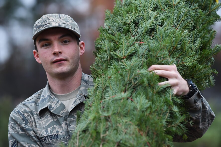 U.S. Air Force Senior Airman Derek Robertson, 1st Operations Support Squadron air traffic controller, carries his free tree to his vehicle during Christmas SPIRIT Foundation’s Trees for Troops program at Joint Base Langley-Eustis, Va., Dec. 5, 2016. Trees for Troops hosted the events at both installations to support both Airmen and Soldiers during the holiday season. (U.S. Air Force photo by Staff Sgt. Natasha Stannard)