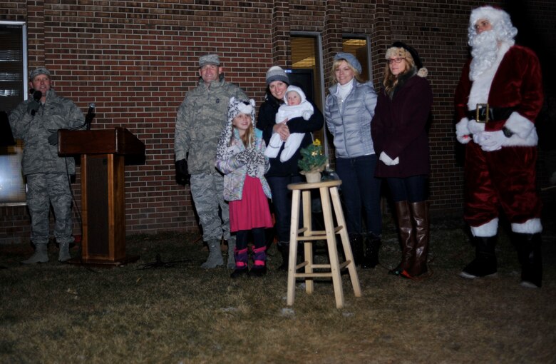 PETERSON AIR FORCE BASE, Colo. –Col. Doug Schiess, 21st Space Wing commander, welcomes members of Team Pete to the 21st SW Holiday Tree Lighting Ceremony at the Peterson chapel, Dec. 2, 2016 at Peterson Air Force Base, Colo. The yearly event is hosted by the chapel offering family arts and crafts activities and food catered by The Club to kick-off the holiday season.  (U.S. Air Force photo by Alethea Smock)