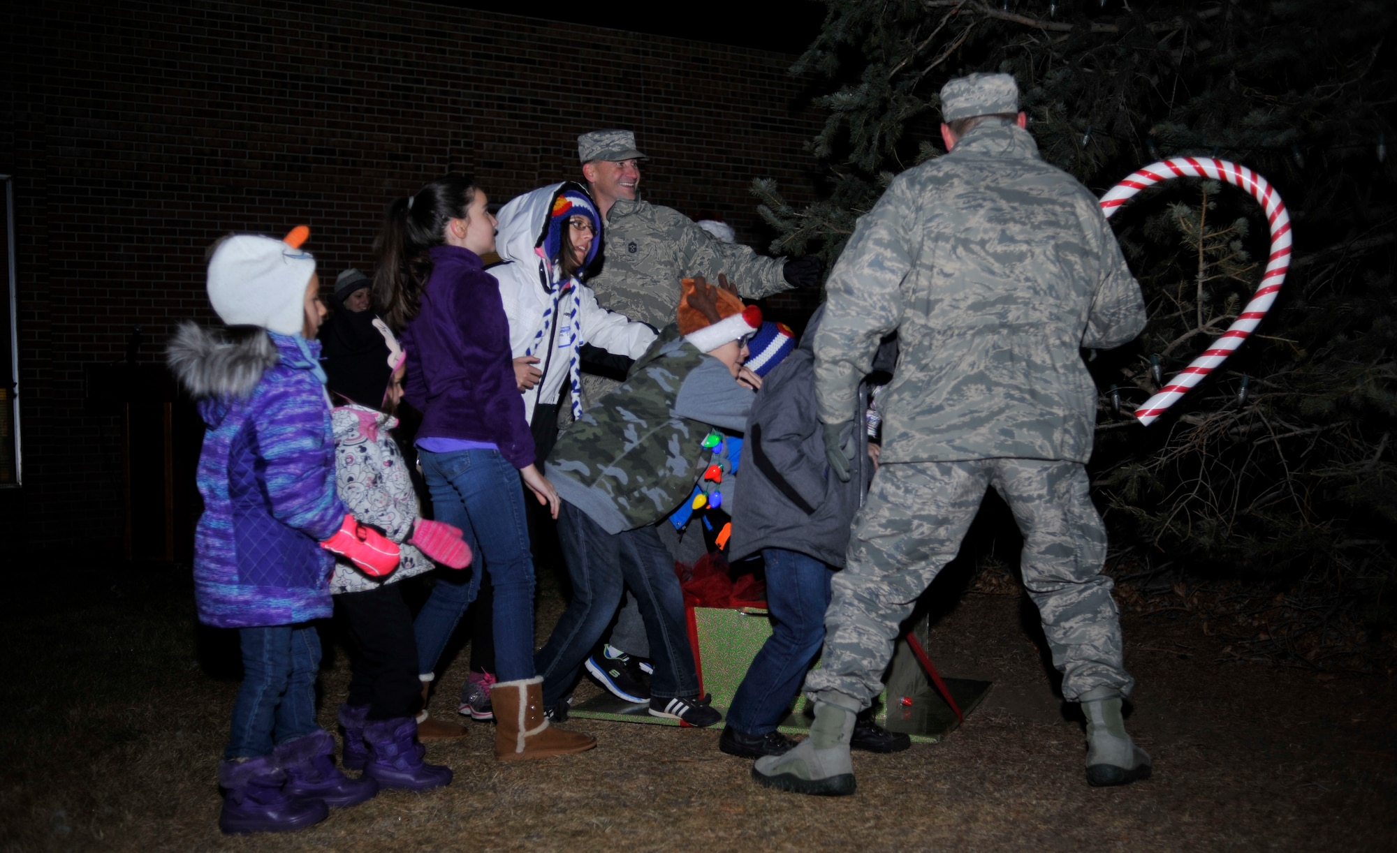 PETERSON AIR FORCE BASE, Colo. –Team Pete kids help Col. Doug Schiess, 21st Space Wing commander,  light the tree at the 21st SW Holiday Tree Lighting Ceremony at the Peterson chapel, Dec. 2, 2016, at Peterson Air Force Base, Colo. The yearly event is hosted by the chapel offering family arts and crafts activities and food catered by The Club to kick-off the holiday season.  (U.S. Air Force photo by Alethea Smock)