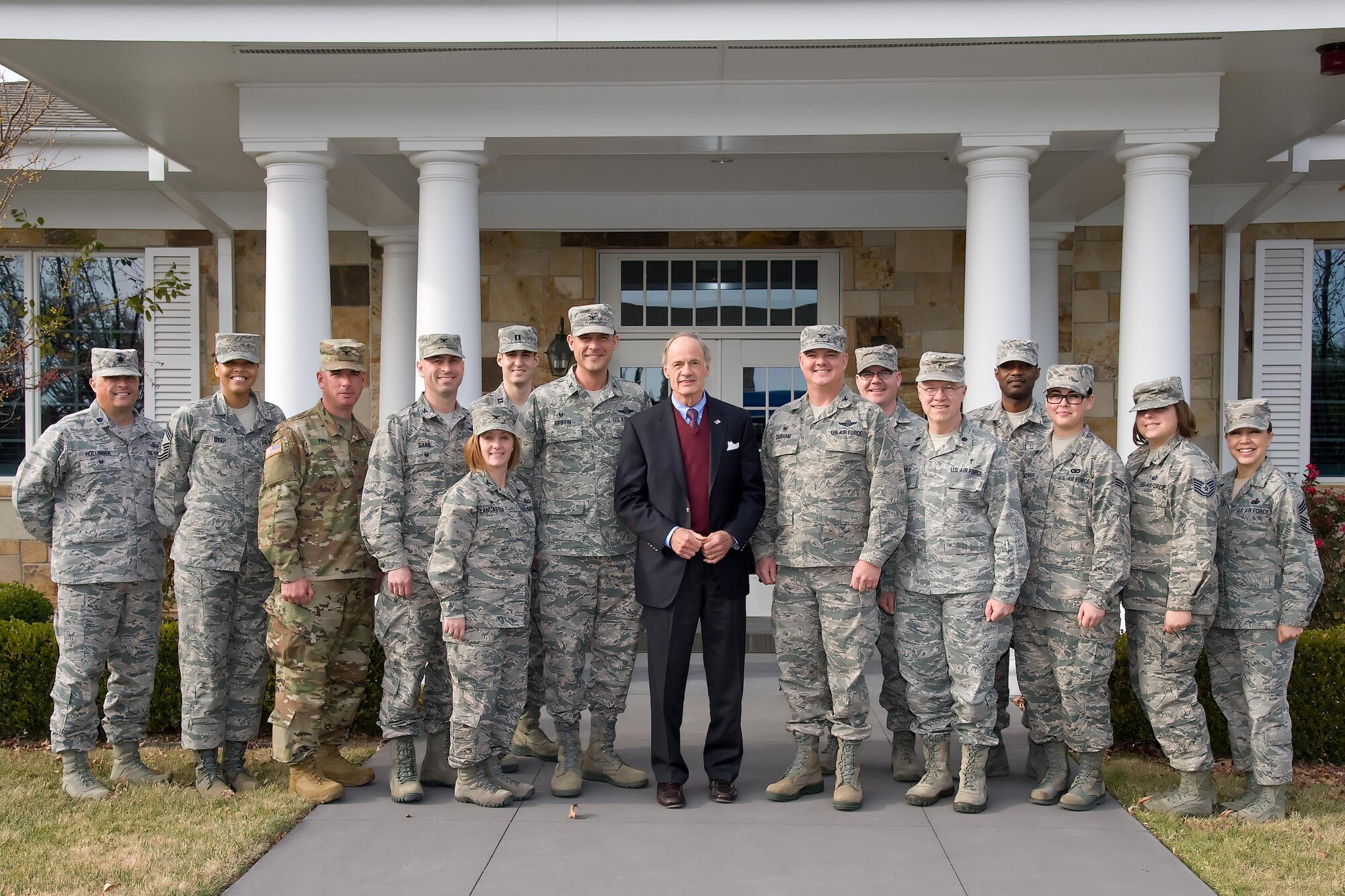 Sen. Tom Carper, D-Del., poses for a photo with Team Dover members outside The Fisher House at the conclusion of his tour Nov. 28, 2016, at Dover Air Force Base, Del. Carper met with senior leadership from the 436th and 512th Airlift Wings, 436th Maintenance Squadron Isochronal Inspection Dock, Air Force Mortuary Affairs Operations, Armed Forces Medical Examiner System, the Joint Personal Effects Depot and The Fisher House. (U.S. Air Force photo by Roland Balik)