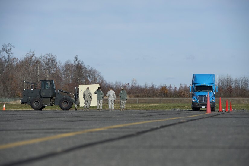 Several leaders from the 436th and 87th Logistics Readiness Squadrons, assigned to Dover Air Force Base, Del., and Joint Base McGuire-Dix-Lakehurst, N.J., respectively, watch competitors complete a timed precision vehicle operation course during the ground transportation rodeo Dec. 2, 2016, at Dover AFB. Both the forklift operator and truck driver had to weave through cones quickly and precisely during the timed event. (U.S. Air Force photo by Senior Airman Aaron J. Jenne)