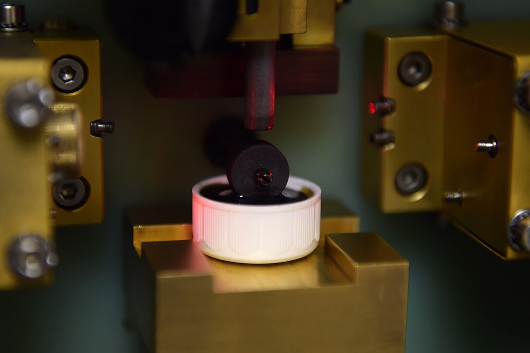 Aircraft oil sits inside of an optical emission spectrometer at Joint Base Langley-Eustis, Va., Dec. 5, 2016. The equipment tests for metal fragments, ensuring the Nondestructive Inspection individuals can locate discrepancies with the oil. (U.S. Air Force photo by Senior Airman Kimberly Nagle)