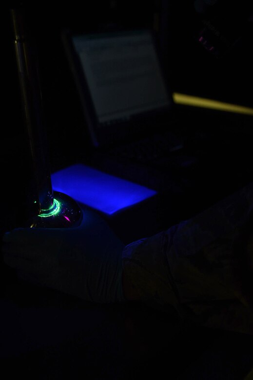 U.S. Air Force Airman 1st Class Shay Oakley, 1st Maintenance Squadron Nondestructive Inspection journeyman, inspects a piece of an aircraft at Joint Base Langley-Eustis, Va., Dec. 5, 2016. After applying a fluorescent penetrant, NDI specialists are able to identify indiscretions on an aircraft part using a black light. (U.S. Air Force photo by Senior Airman Kimberly Nagle)  