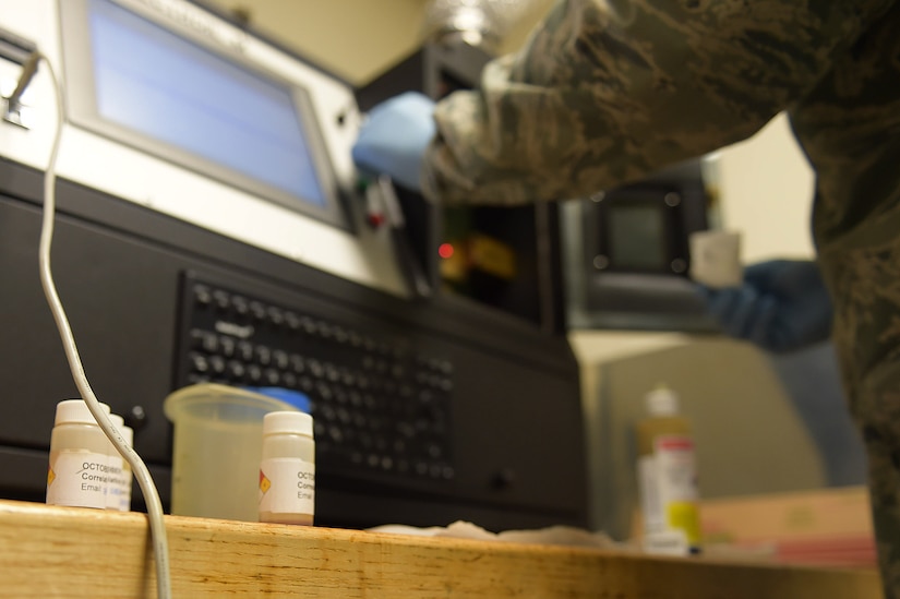 U.S Air Force Senior Airman Rickey Godette, 1st Maintenance Squadron Nondestructive Inspection journeyman, prepares aircraft oil to be analyzed at Joint Base Langley-Eustis, Va., Dec. 5, 2016. NDI individuals use this test as a way to track any discrepancies within the oil. (U.S. Air Force photo by Senior Airman Kimberly Nagle)