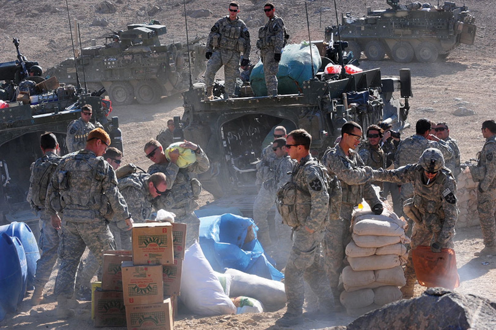 U.S. Soldiers transport and unpack humanitarian aid to an Afghani town.