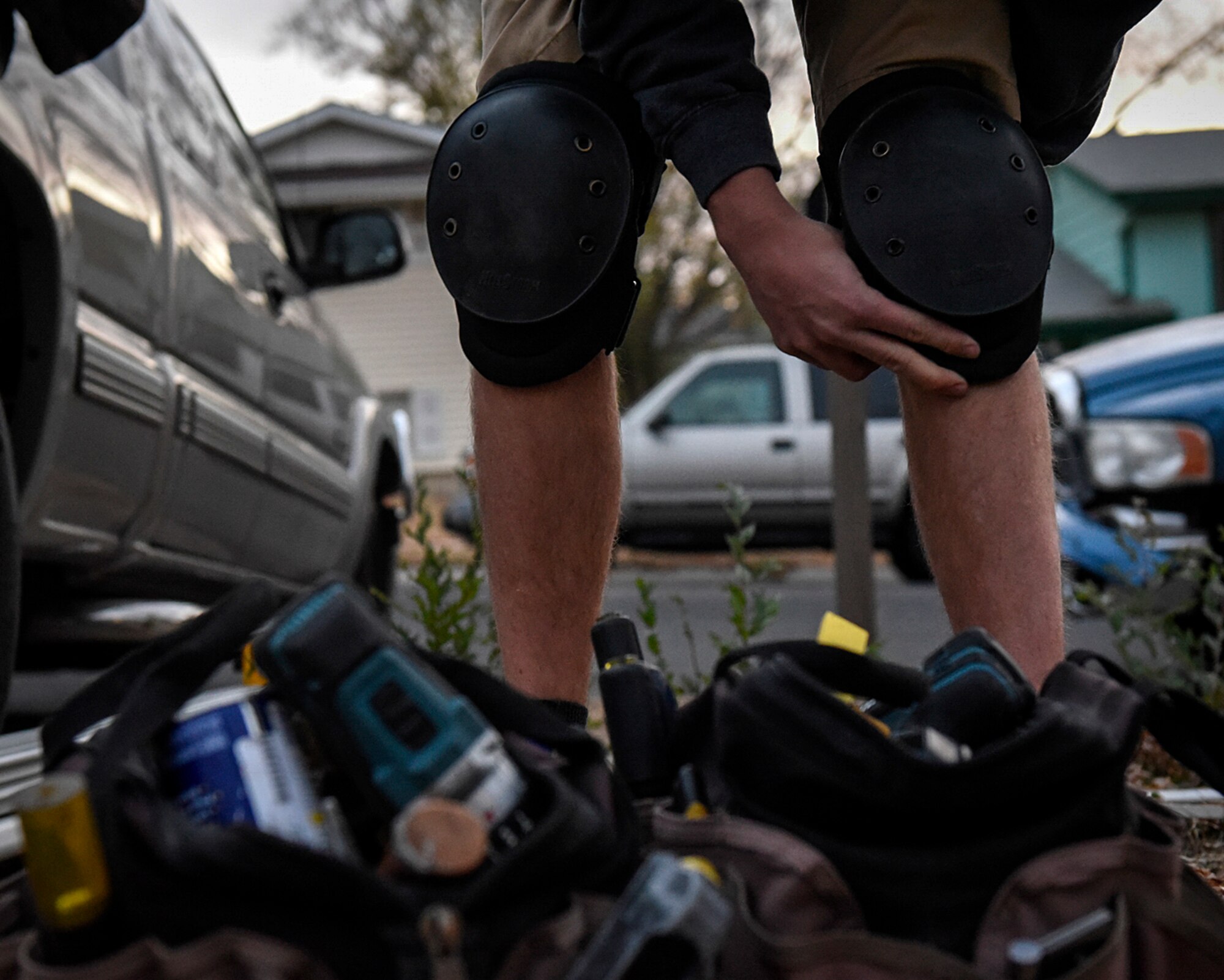 COLORADO SPRINGS, Colo. – A member of the 21st Civil Engineer Squadron structures team at Peterson Air Force Base, Colo., straps knee pads on at the house of a fellow Airman in Colorado Springs, Nov. 5, 2016. Volunteers from Peterson helped install new flooring for a family to make it safe for medical needs. (U.S. Air Force photo by Senior Airman Rose Gudex)