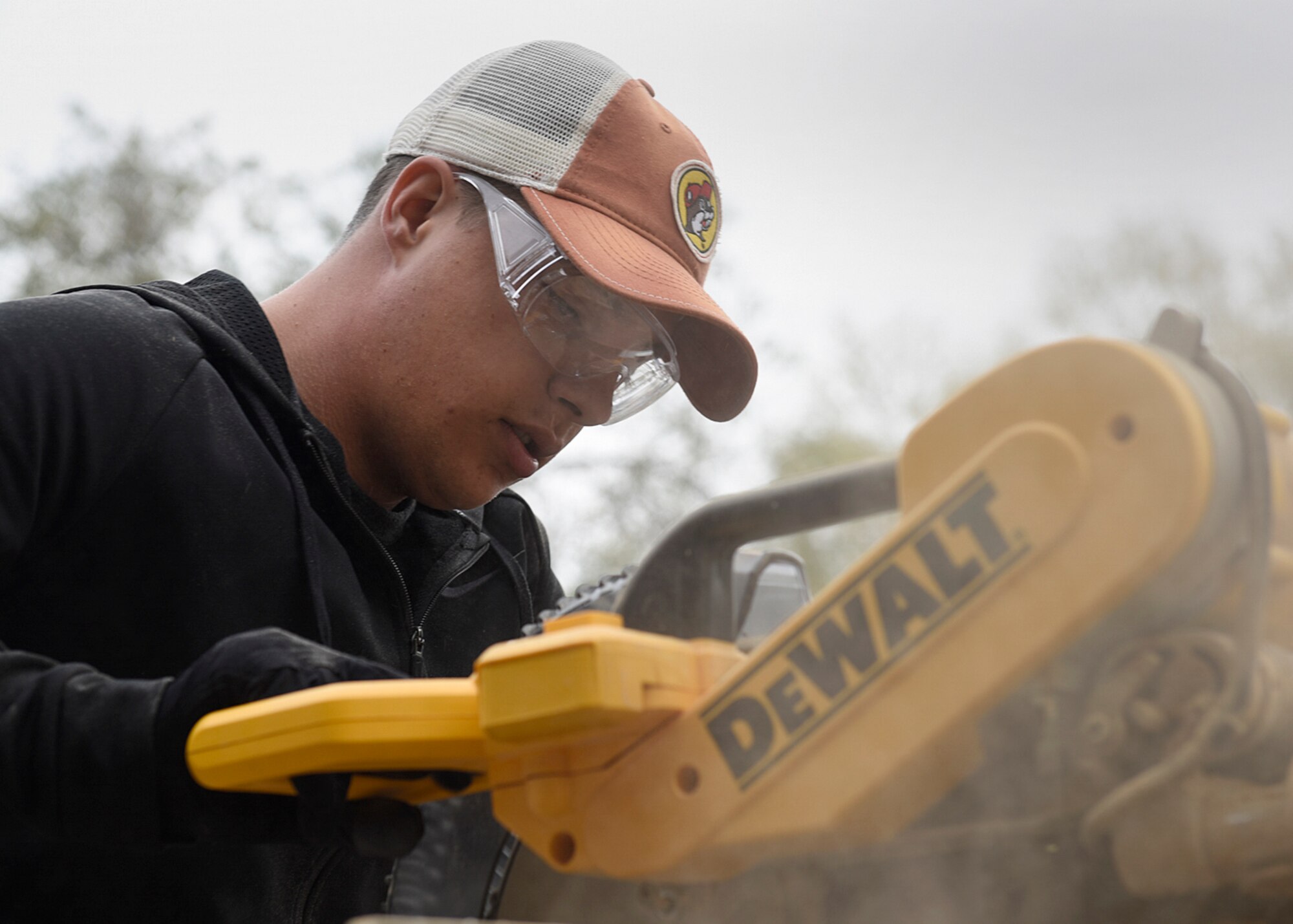 COLORADO SPRINGS, Colo. – Airman Gavin Ruddick, 21st Civil Engineer Squadron structures shop at Peterson Air Force Base, Colo., cuts flooring to install in a fellow Airman’s home in Colorado Springs, Nov. 5, 2016. Airmen from Peterson AFB volunteered to help install flooring in the home to prepare for a sick family member to return from an extended hospital stay. (U.S. Air Force photo by Senior Airman Rose Gudex)