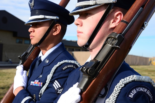 Senior Airman Caleb Buenconsejo, 341st Missile Maintenance Squadron electromechanical team technician, left, and Airman 1st Class Taylor Brown, 741st Maintenance Squadron power refrigeration and electrical lab technician and prior member of the Malmstrom Honor Guard, practice present arms Nov. 4, 2016, at Malmstrom Air Force Base, Mont. Honor guard members must be able to execute a variety of movements for flag demonstrations, veteran and active duty funerals. (U.S. Air Force photo/Airman 1st Class Magen M. Reeves)