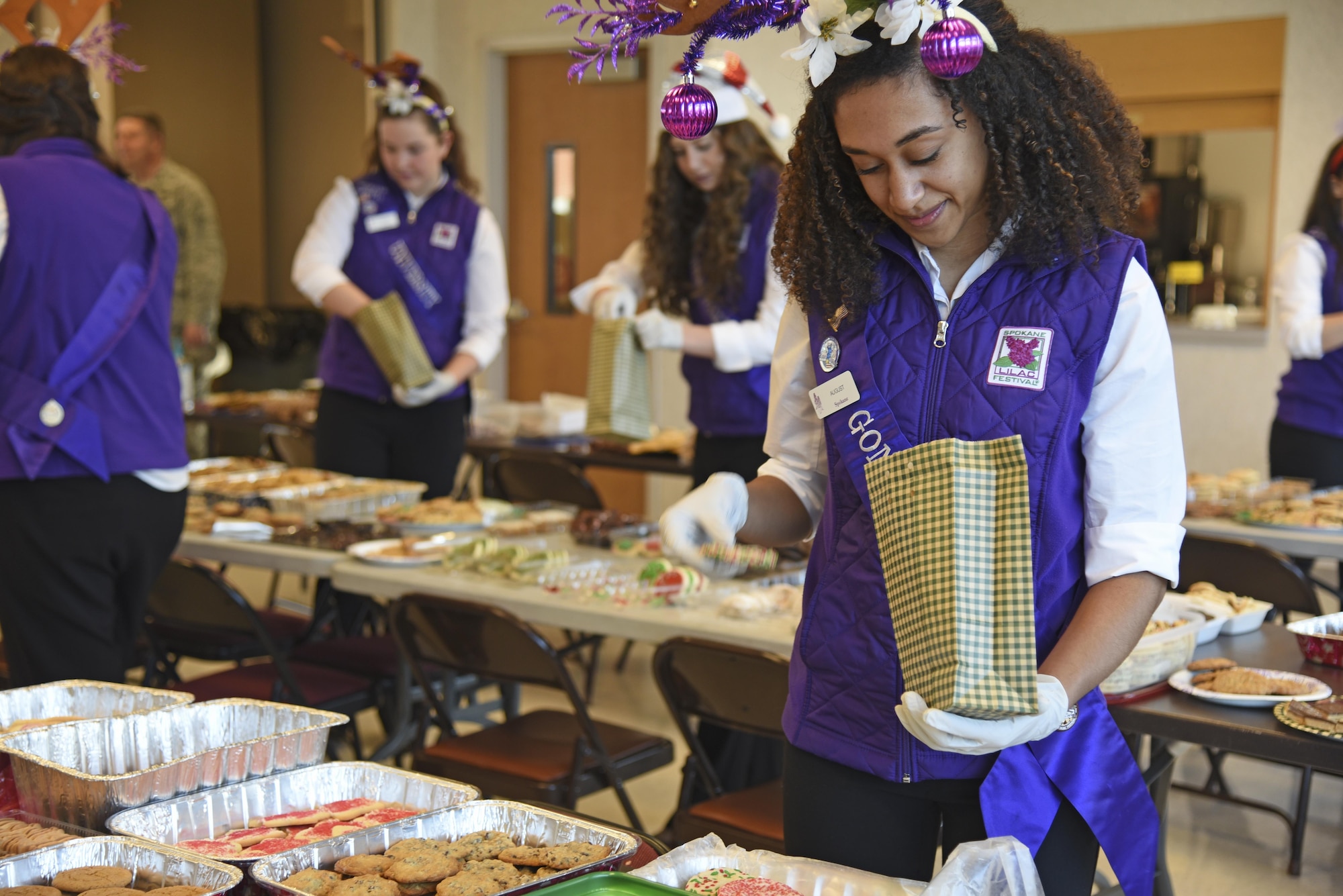 August Corppetts, Spokane Lilac Festival Princess and Gonzaga Preparatory School student, fills a bag with homemade cookies during the annual Operation Cookie Drop Dec. 6, 2016, at Fairchild Air Force Base. The Spokane Lilac Festival Princesses partnered with Officer’s Spouses Club to pack nearly 500 bags with cookies for Fairchild Airmen living in the dormitories. (U.S. Air Force photo/Senior Airman Mackenzie Richardson)
