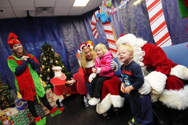 Mackenzie and Kayden Riccardelli visit Santa and Mrs. Claus during the 2016 Candy Land Children’s Holiday Fest at Schriever Air Force Base, Colorado, Saturday, Dec. 3, 2016. Families waited in line to see Santa during the free 50th Force Support Squadron event. (U.S. Air Force photo/1st Lt. Darren Domingo)