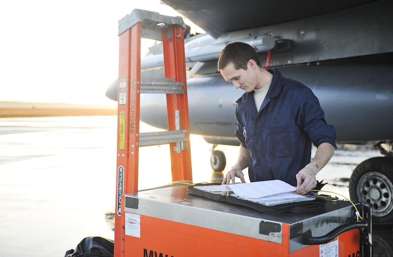 U.S. Air Force Airman 1st Class Morgan Cisna, an F-15E Strike Eagle crew chief with the 391st Aircraft Maintenance Squadron, Mountain Home Air Force Base, Idaho, inspects the paperwork of an F-15E before takeoff at Tyndall AFB, Fla., Dec. 5, 2016. Cisna is one of more than 300 personnel sent from Mountain Home to participate in Checkered Flag 17-1. (U.S. Air Force photo by Senior Airman Dustin Mullen/Released)