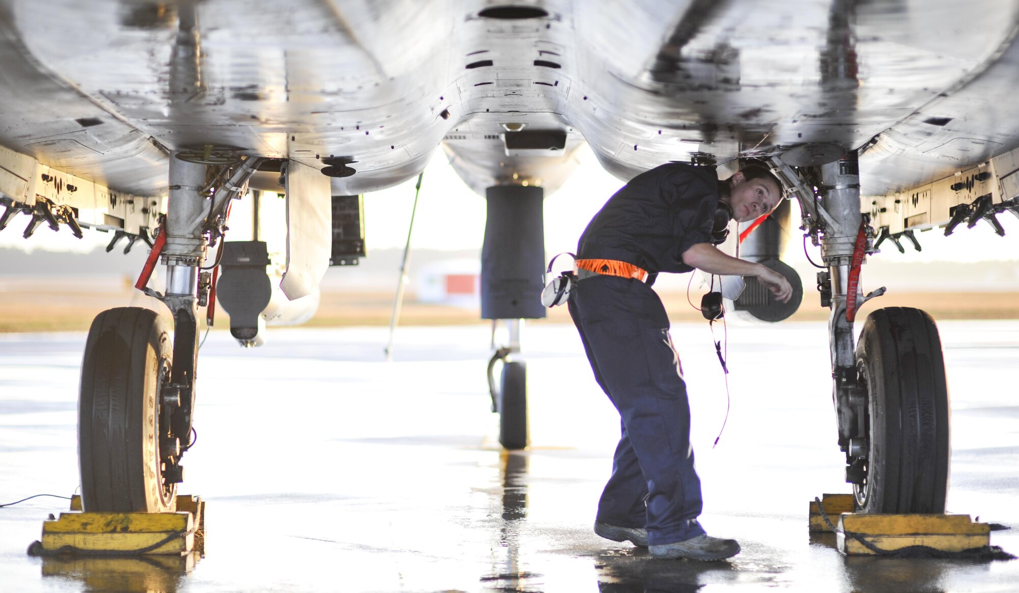 U.S. Air Force Airman 1st Class Morgan Cisna, an F-15E Strike Eagle crew chief with the 391st Aircraft Maintenance Squadron, Mountain Home Air Force Base, Idaho, inspects the underside of an F-15E before takeoff at Tyndall AFB, Fla., Dec. 5, 2016. The F-15Es are taking part in Checkered Flag 17-1, a large scale total force integration exercise that gives legacy and fifth-generation aircraft a chance to train together in a simulated deployed environment. (U.S. Air Force photo by Senior Airman Dustin Mullen/Released)