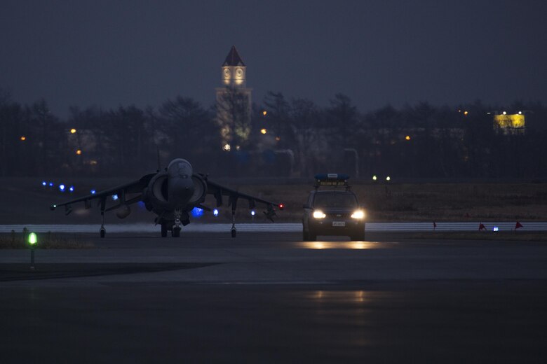 A U.S. Marine Corps AV-8B Harrier with Marine Attack Squadron (VMA) 542 is escorted to the flight line after landing at Chitose Air Base, Japan, Dec. 5, 2016. Four Harriers flew from Atsugi to partake in the Aviation Relocation Training Program. Following the arrival of the squadron’s Harriers, a press conference was held to acknowledge questions pertaining to the aircraft and the ATR. (U.S. Marine Corps photo by Lance Cpl. Joseph Abrego)