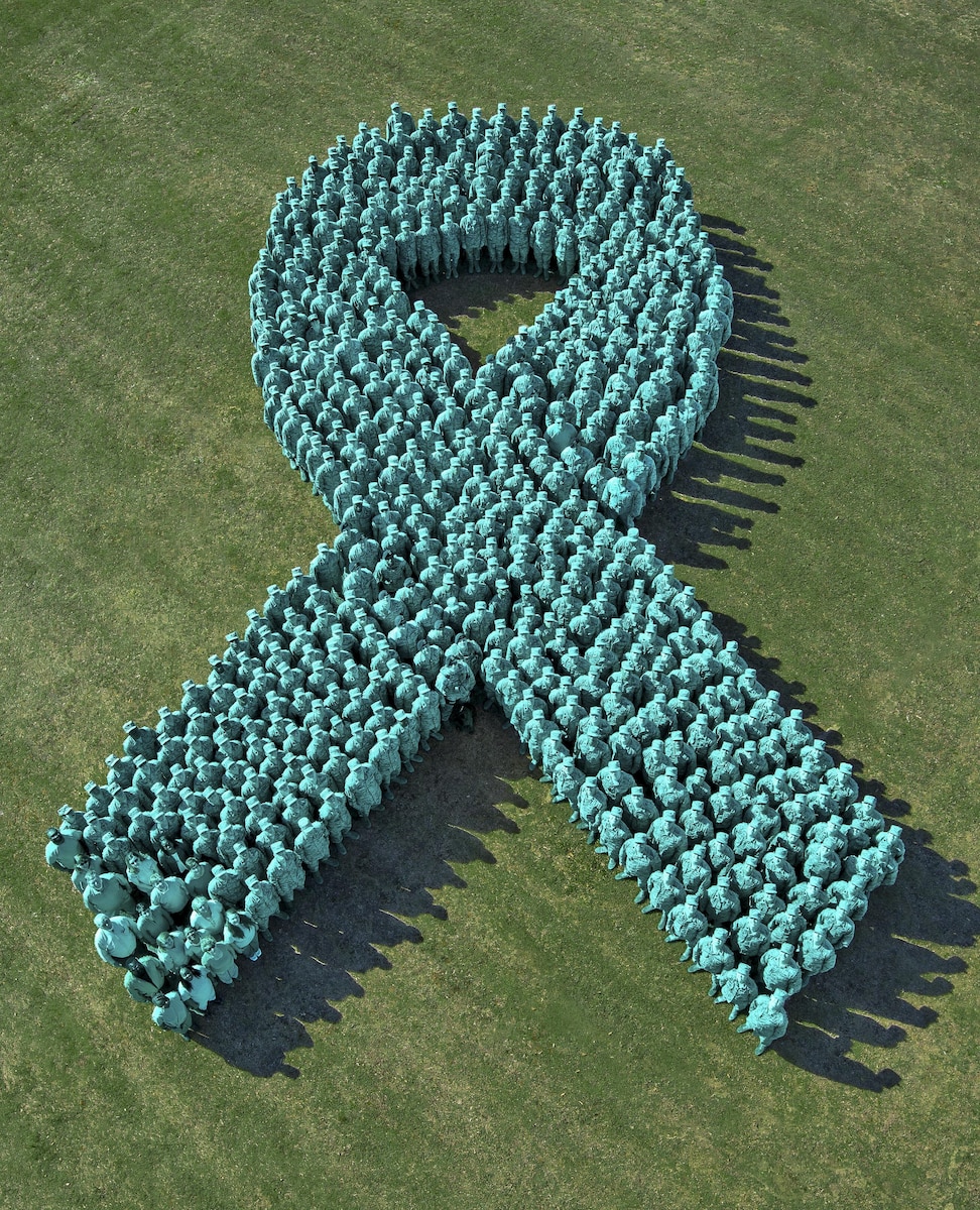 Air University and 42nd Air Base Wing personnel unite to take a stand against sexual assault at Maxwell Air Force Base in Montgomery, Ala., April 5, 2016. The event marks Sexual Assault Awareness Month, which aims to raise public awareness about sexual violence and to educate on how to prevent it. The image is a photo illustration in which a teal color overlay was placed on the group to represent a sexual assault ribbon. Air Force photo illustration by Donna L. Burnett