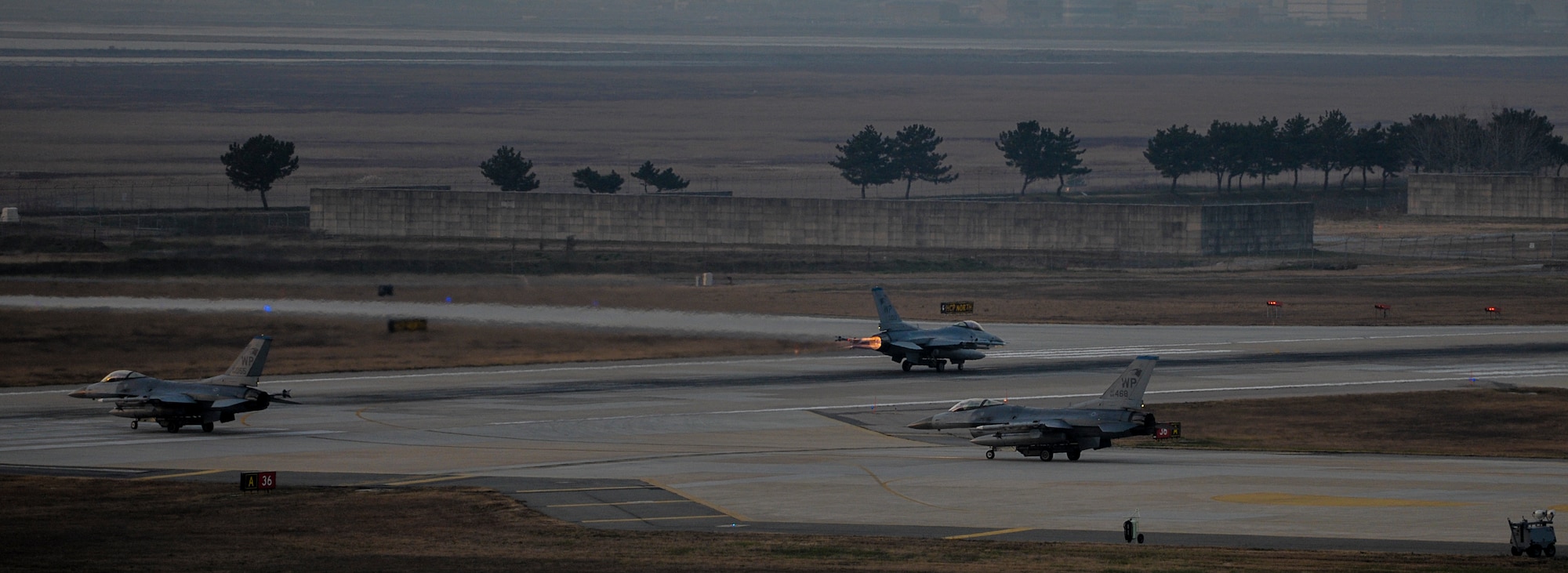 U.S. Air Force F-16 Fighting Falcons from the 35th Fighter Squadron prepare to take off at Kunsan Air Base, Republic of Korea, Dec. 3, 2016. Aircrews here regularly train alongside aircrews flying different types of aircraft. This interoperability enables our members to be ready for many potential situations. (U.S. Air Force photo by Senior Airman Colville McFee/Released)
