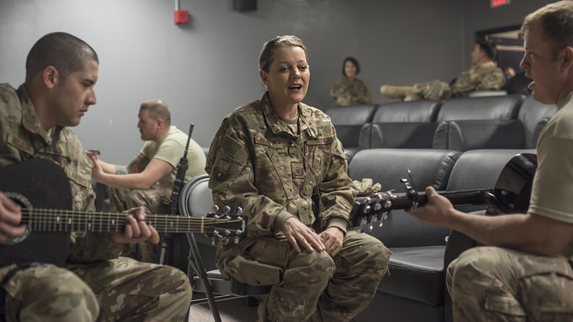 Staff Sgt. Alberto Rosado Perez and Master Sgt. Julie Bradley, U.S. Air Forces Central Command Band members, give music lessons during “School of Rock,” Dec. 5, 201 6 at Bagram Airfield, Afghanistan. The Hyper Sonic ensemble offered a “School of Rock” session to answer questions from Bagram service members. (U.S. Air Force photo by Staff Sgt. Katherine Spessa)
