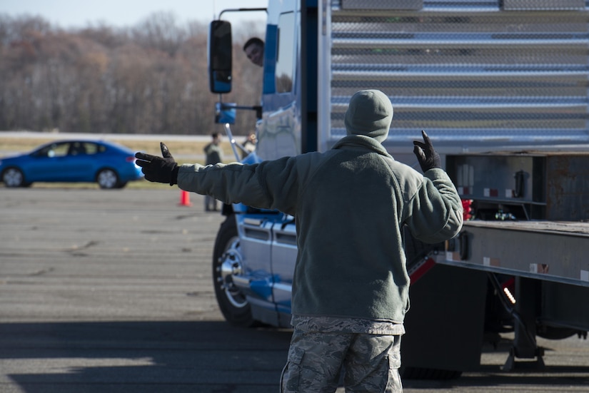 Staff Sgt. Ryan Mack, 87th Logistics Readiness Squadron vehicle operator, directs Airman 1st Class Justin Wheeler, 87th LRS vehicle operator, while he backs a truck between cones during the ground transportation rodeo Dec. 2, 2016, at Dover Air Force Base, Del. Six, two-man teams from the 436th and 87th Logistics Readiness Squadrons, assigned to Dover AFB and Joint Base McGuire-Dix-Lakehurst, N.J., respectively, competed in the competition. (U.S. Air Force photo by Senior Airman Aaron J. Jenne)