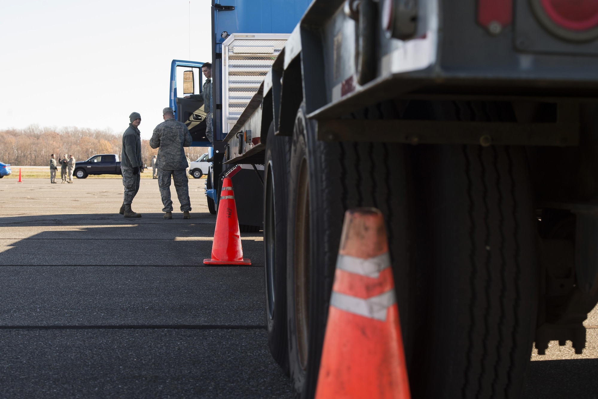 A tractor trailer is parked parallel between cones while vehicle operations Airmen discuss maneuver execution during the ground transportation rodeo at Dover Air Force Base, Del. Airmen from the 87th Logistics Readiness Squadron traveled from Joint Base McGuire-Dix-Lakehurst to participate in the event with Team Dover’s 436th LRS. (U.S. Air Force photo by Senior Airman Aaron J. Jenne)