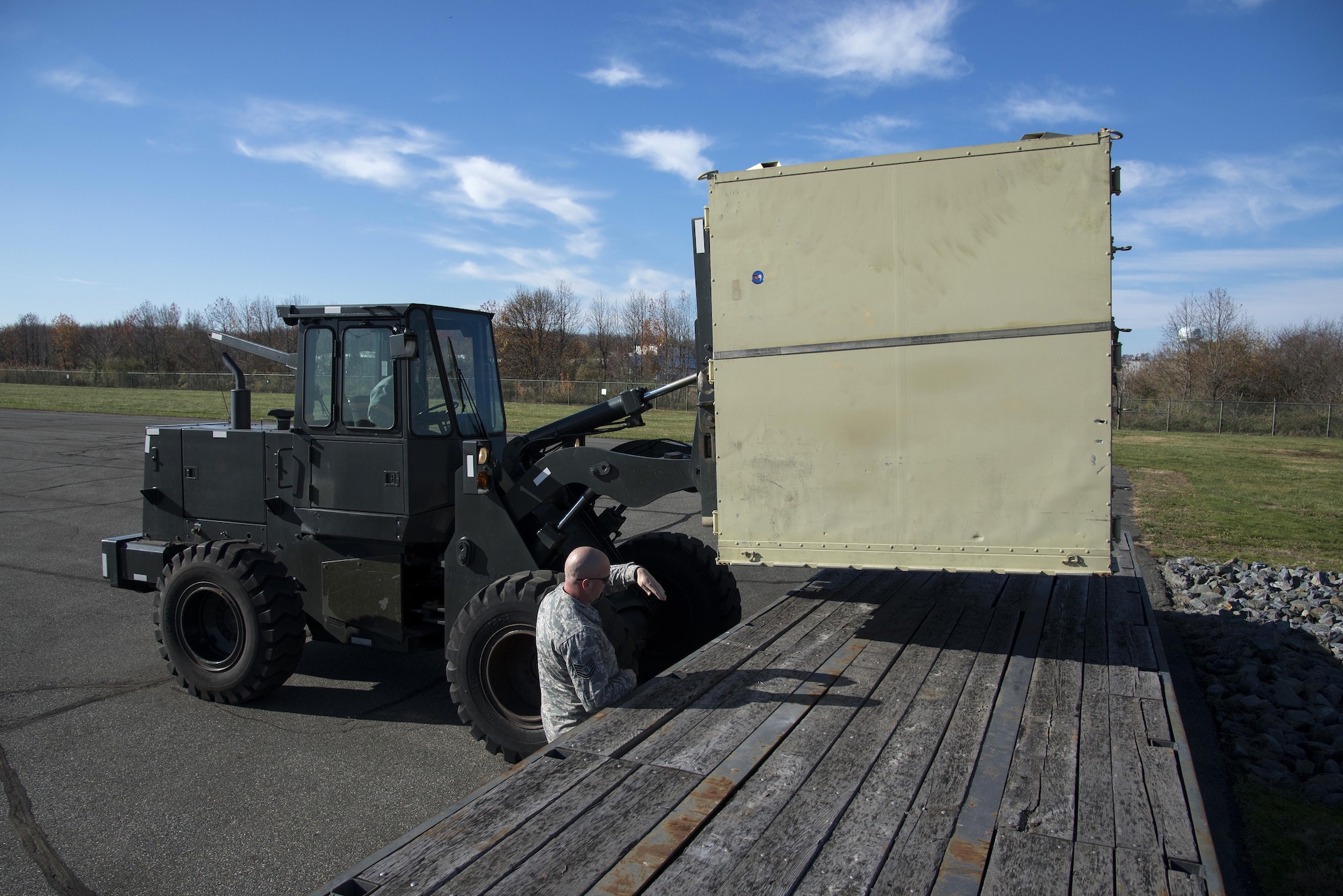 Tech. Sgt. Joshua Casey, 436th Logistics Readiness Squadron NCO in charge of vehicle operations control center support, uses hand signals to direct forklift operations during the ground transportation rodeo Dec. 2, 2016, at Dover Air Force Base, Del. Members of the 436th LRS invited Airmen from the 87th LRS assigned to Joint Base McGuire-Dix-Lakehurst, N.J., to compete in the first event of its kind, from which coordinators intended to improve morale, showcase precision vehicle operation and improve training through friendly competition. (U.S. Air Force photo by Senior Airman Aaron J. Jenne)