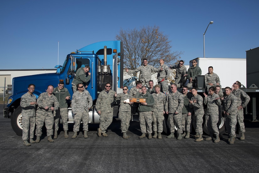Vehicle operations Airmen assigned to the 436th and 87th Logistics Readiness Squadrons, from Dover Air Force Base, Del., and McGuire-Dix-Lakehurst, N.J., respectively, pose for a group photo after the ground transportation rodeo Dec. 2, 2016, at Dover AFB. Team MDL took home the traveling trophy after winning both the team and overall time categories. (U.S. Air Force photo by Senior Airman Aaron J. Jenne)