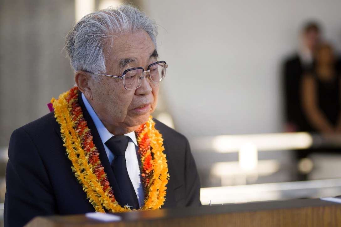 Dr. Hiroya Sugano, director general of the Zero Fighter Admirers Club, speaks at the 6th annual Blackened Canteen ceremony at the USS Arizona Memorial during the 75th Commemoration of the attacks on Pearl Harbor, Hawaii, Dec. 6, 2016. Navy photo by Petty Officer 2nd Class Somers Steelman