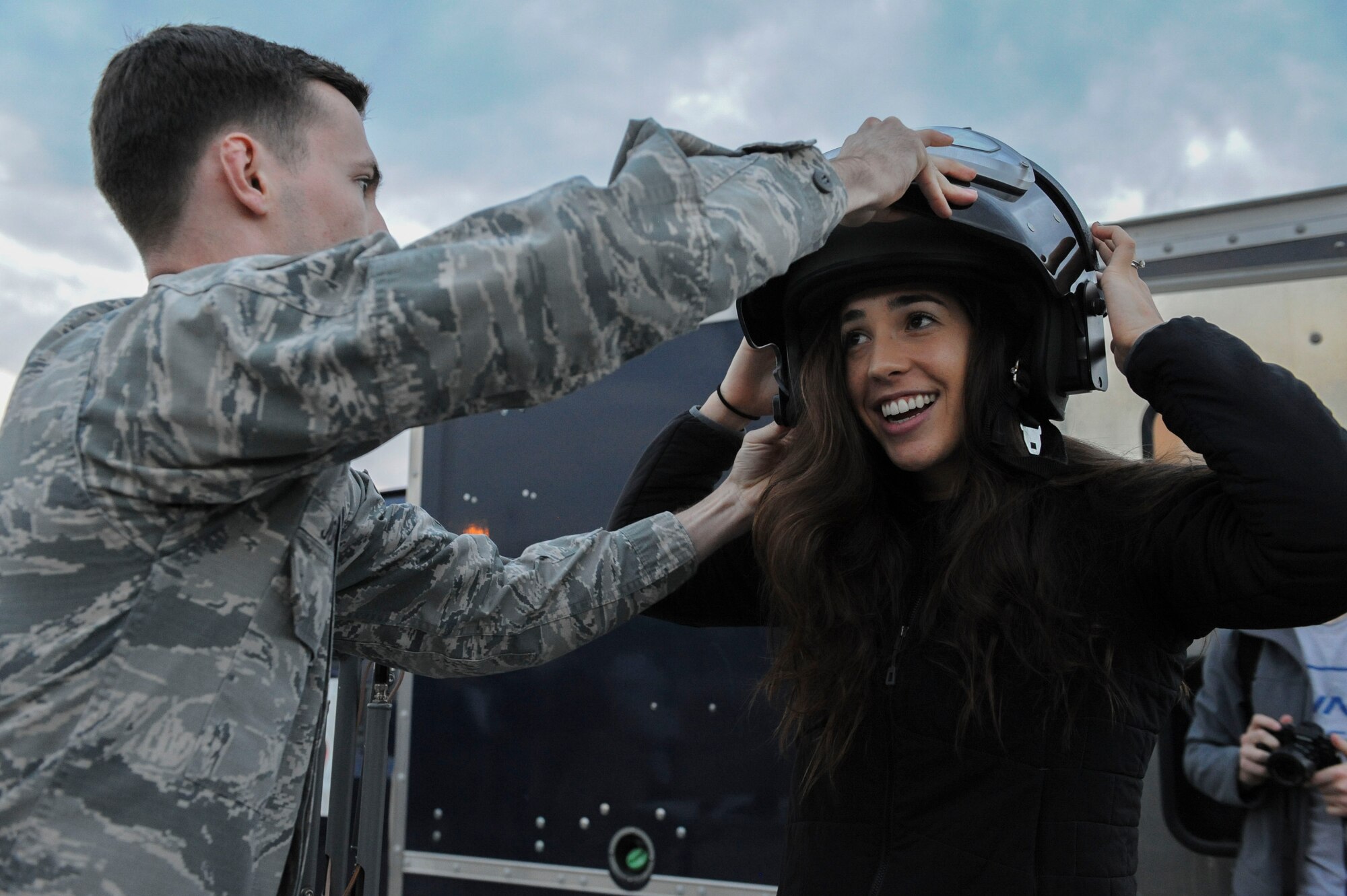 U.S. Air Force Senior Airman Alex Johnson, a 39th Civil Engineer Squadron explosive ordnance disposal journeyman, helps Four-time Olympic medalist Maya DiRado put on a bomb suit helmet Dec. 5, 2016, at Incirlik Air Base, Turkey. DiRado was one of the USO entertainers that accompanied U.S. Marine Corps Gen. Joseph F. Dunford, Jr., chairman of the Joint Chiefs of Staff, on the 2016 USO Holiday Visit. (U.S. Air Force photo by Airman 1st Class Devin M. Rumbaugh)