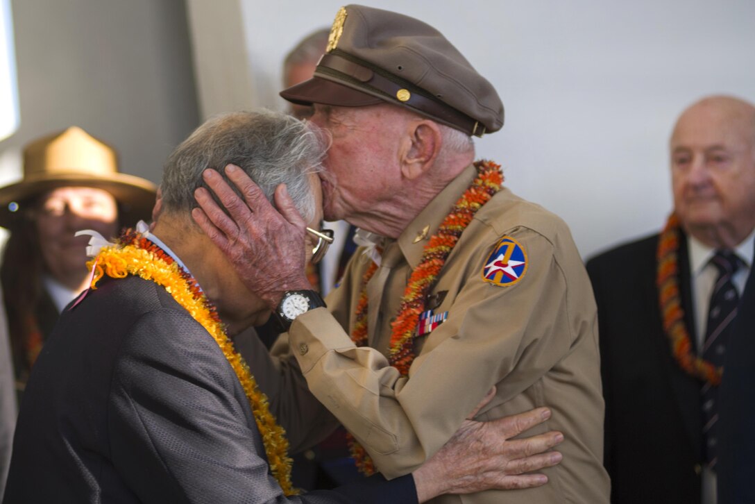 Jerry Yellin, former captain and World War II Army Air Force P-51 pilot, embraces Dr. Hiroya Sugano, director general of the Zero Fighter Admirers Club, during the 6th annual Blackened Canteen ceremony at the USS Arizona Memorial during the 75th commemoration of the attacks on Pearl Harbor, Hawaii, Dec. 6, 2016. Navy photo by Petty Officer 2nd Class Somers Steelman