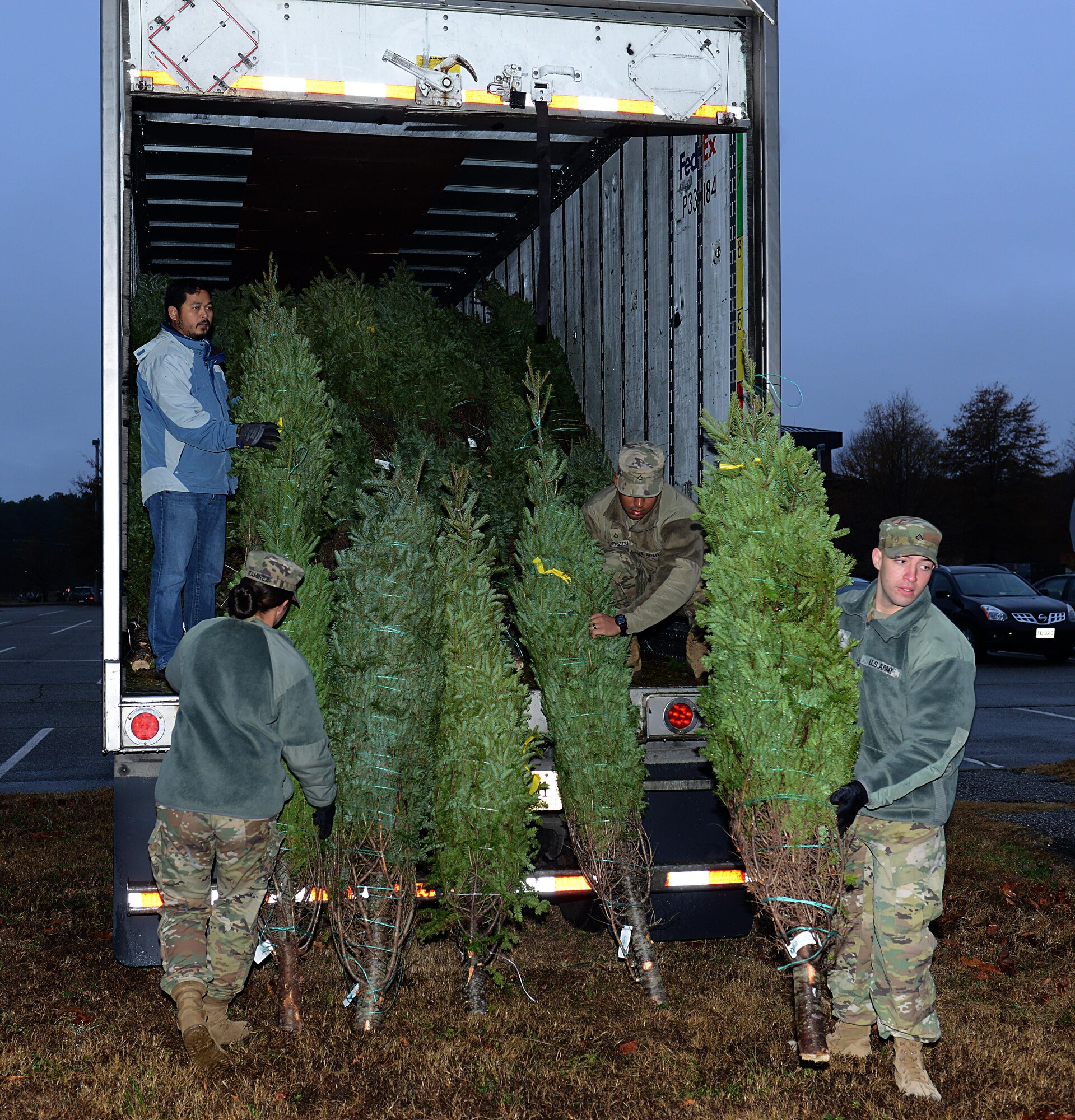 U.S. Army Soldiers volunteer to unload a truck of fresh-cut trees from the Christmas SPIRIT Foundation’s Trees for Troops program at Joint Base Langley-Eustis, Va., Dec. 5, 2016. Active duty service members and their spouses picked out a free tree donated by various tree farms across the country. (U.S. Air Force photo by Staff Sgt. Teresa J. Cleveland)
