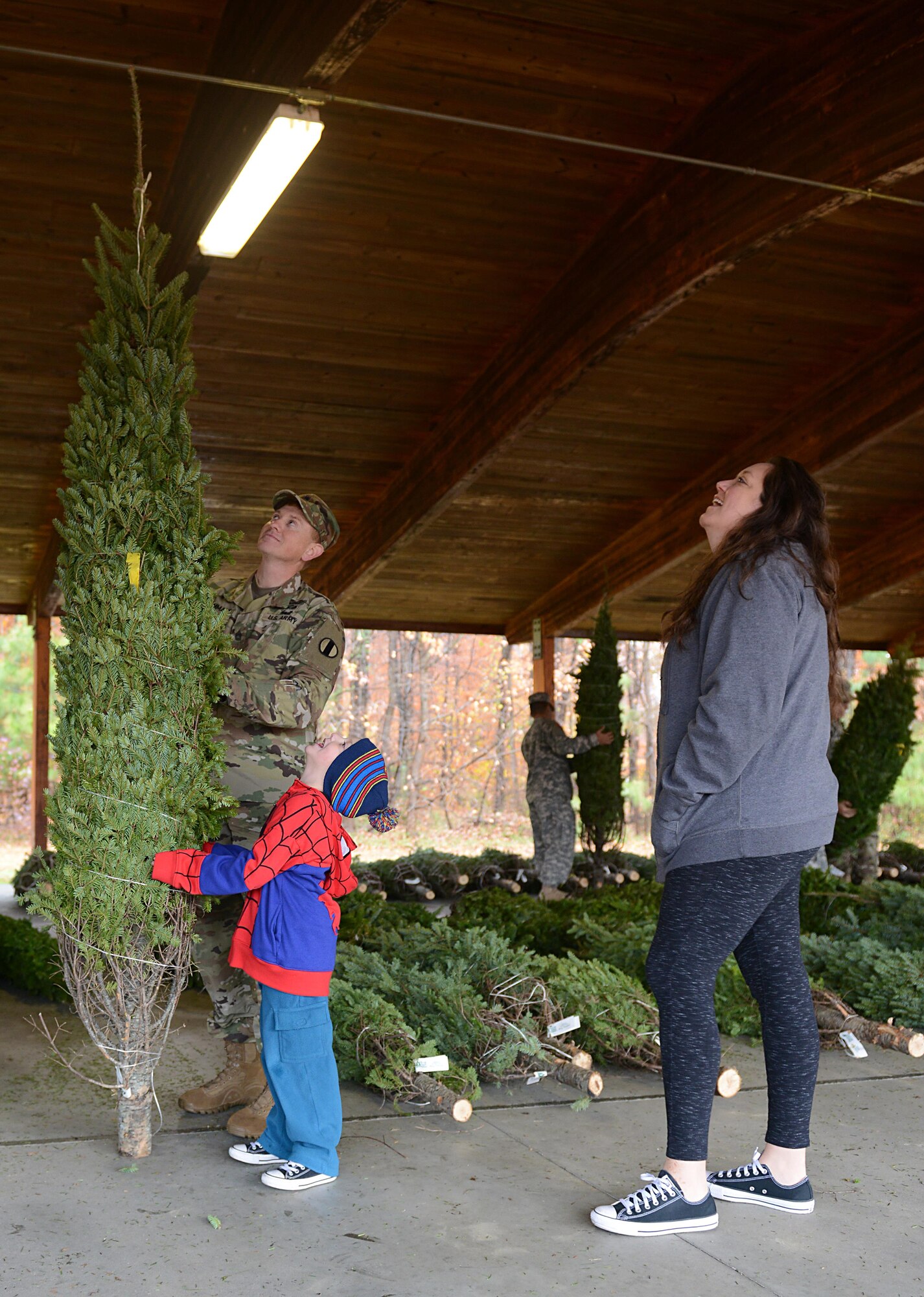 U.S. Army Sgt. 1st Class George Wommack, U.S. Army Training and Doctrine Command facilities management NCO, his wife Jaime and son Grayson, age 4, pick out a tree from the Christmas SPIRIT Foundation’s Trees for Troops program at Joint Base Langley-Eustis, Va., Dec. 5, 2016. Fort Eustis has participated in the program for eight years, while this was the second year for Langley Air Force Base. (U.S. Air Force photo by Staff Sgt. Teresa J. Cleveland)