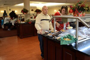U.S. Army Sgt. Matt Johns, 221st Military Police Detachment officer, and his daughter Nikita, age 18, select food from the buffet during the brunch with Santa event at Joint Base Langley-Eustis, Va., Dec. 4, 2016. The brunch is one of many events hosted by the Fort Eustis Club and the installation to bring in the holiday season. (U.S. Air Force photo by Staff Sgt. Teresa J. Cleveland)